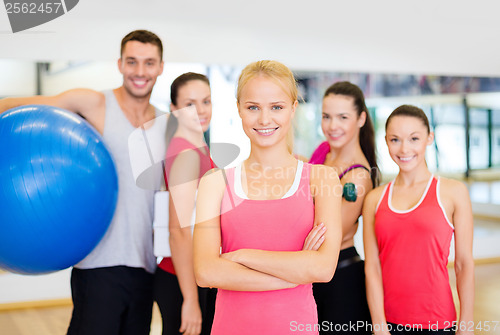 Image of woman standing in front of the group in gym