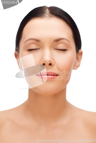 Image of relaxed young woman with closed eyes