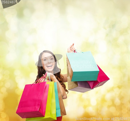 Image of woman in red dress with colorful shopping bags