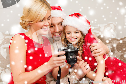 Image of family in santa helper hats looking at pictires