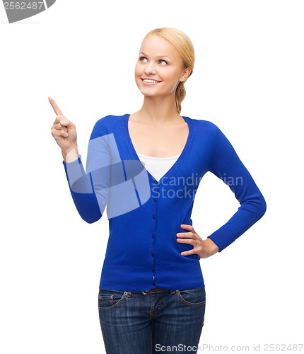 Image of smiling woman pointing her finger up