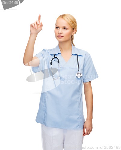 Image of smiling doctor or nurse pointing to something