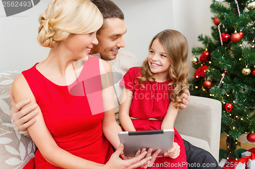 Image of smiling family with tablet pc