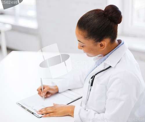 Image of female doctor writing prescription