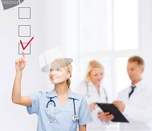 Image of doctor or nurse drawning checkmark into checkbox