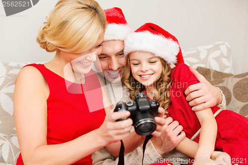 Image of family in santa helper hats looking at pictires