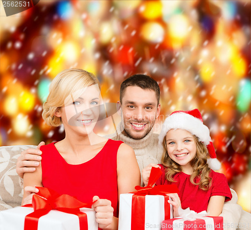 Image of smiling family holding many gift boxes