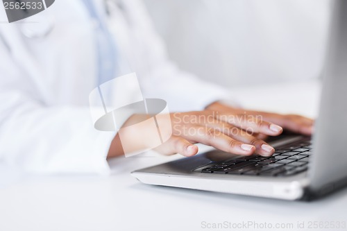 Image of female doctor using her laptop computer