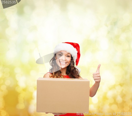 Image of smiling woman in santa helper hat with parcel box