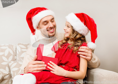 Image of smiling father and daughter opening gift box