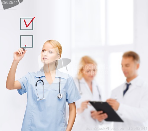 Image of doctor or nurse drawning checkmark into checkbox