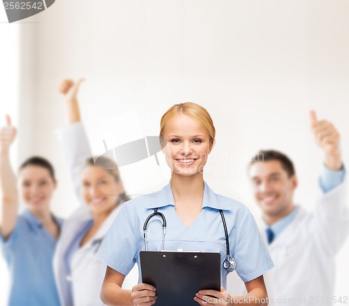 Image of smiling female doctor or nurse with clipboard