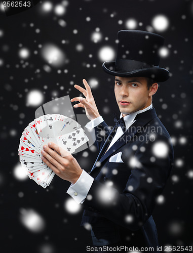 Image of magician showing trick with playing cards