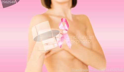 Image of hand holding pink breast cancer awareness ribbon