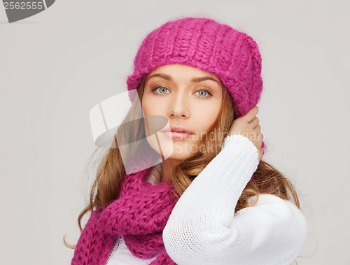 Image of woman in pink hat and scarf