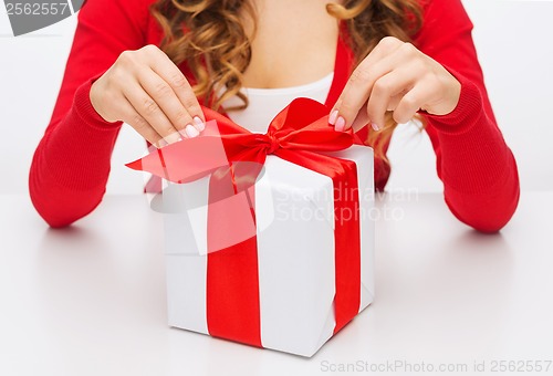 Image of woman hands opening gift boxes