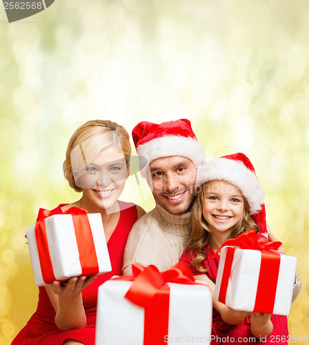 Image of smiling family giving many gift boxes