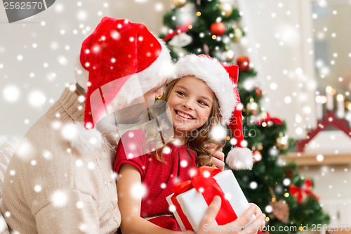 Image of smiling father and daughter holding gift box