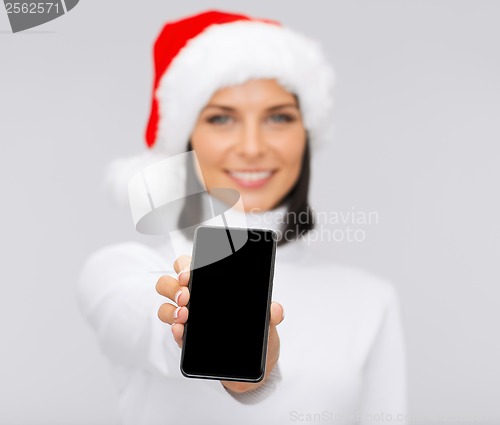 Image of smiling woman in santa helper hat with smartphone