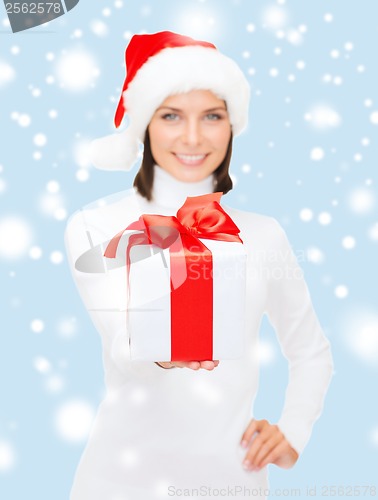 Image of woman in santa helper hat holding gift box