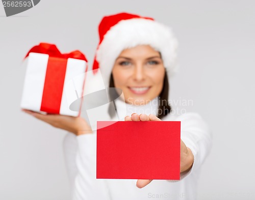 Image of smiling woman in santa helper hat with postcard