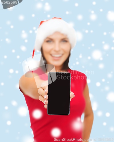 Image of smiling woman in santa helper hat with smartphone