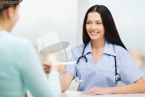 Image of smiling doctor or nurse with patient