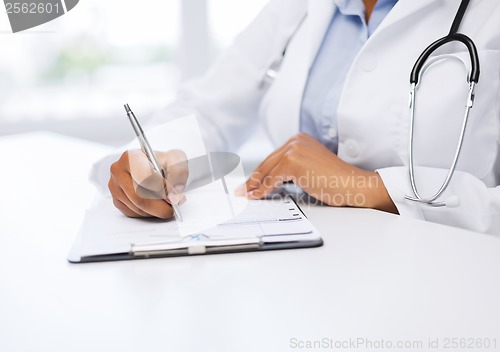 Image of female doctor writing prescription