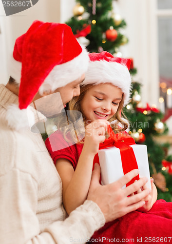 Image of smiling father and daughter opening gift box