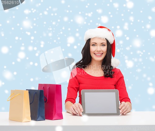 Image of woman in santa helper hat with tablet pc