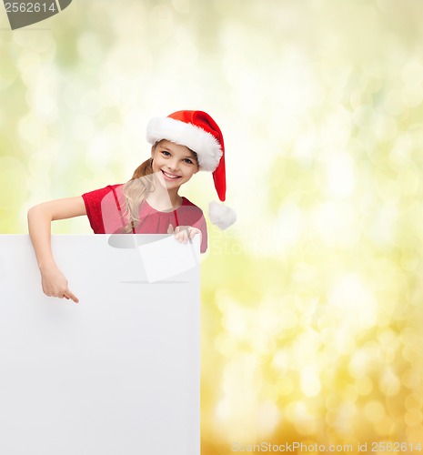 Image of child in santa helper hat with blank white board