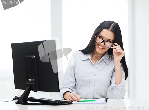 Image of smiling businesswoman or student with eyeglasses