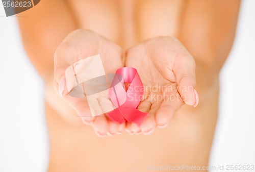 Image of hands holding pink breast cancer awareness ribbon