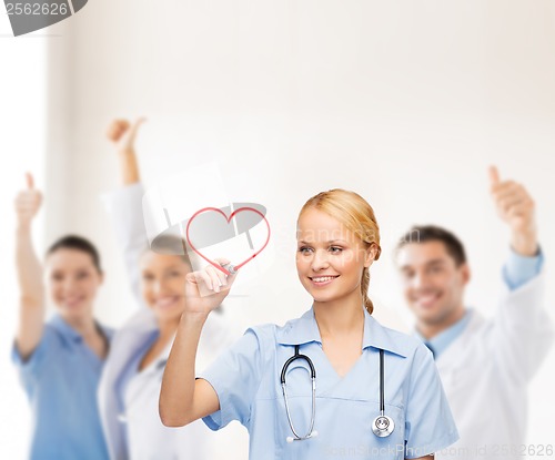 Image of smiling doctor or nurse drawing red heart