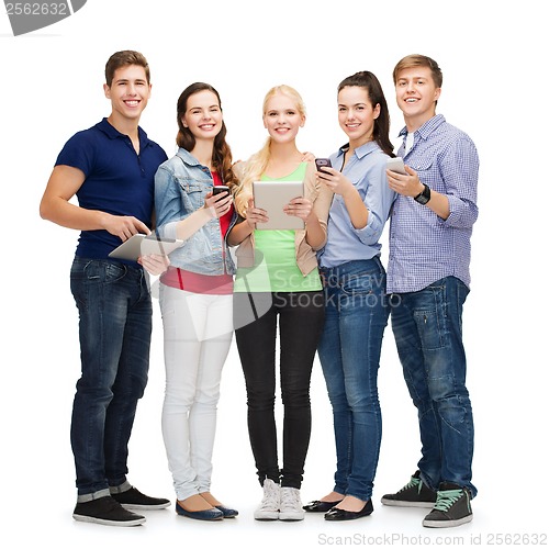 Image of smiling students using smartphones and tablet pc