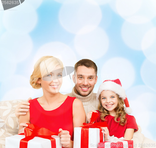 Image of smiling family holding many gift boxes