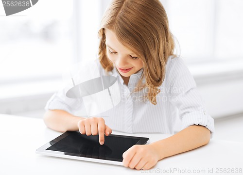 Image of smiling little girl with tablet pc at school