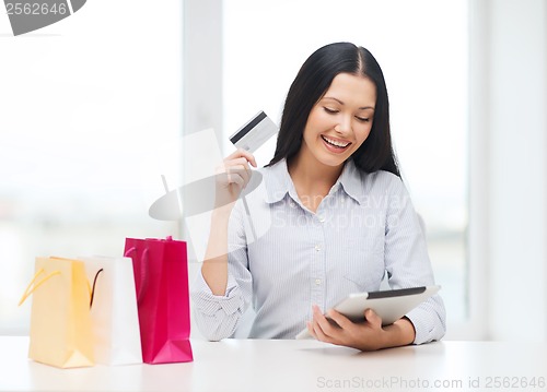 Image of smiling woman with blank screen tablet pc