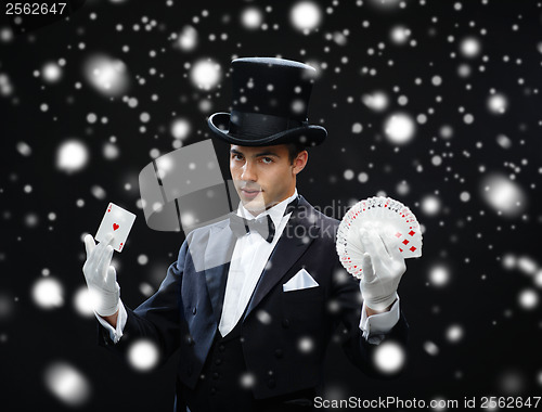 Image of magician showing trick with playing cards