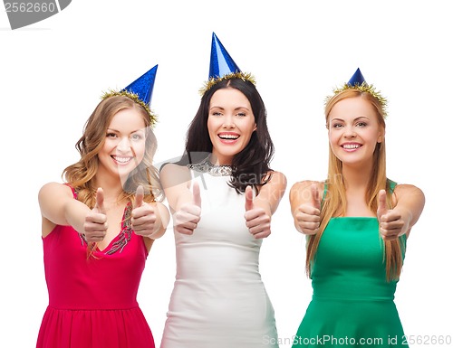 Image of three women wearing hats and showing thumbs up
