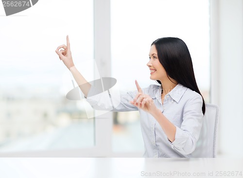 Image of smiling woman pointing to something imaginary