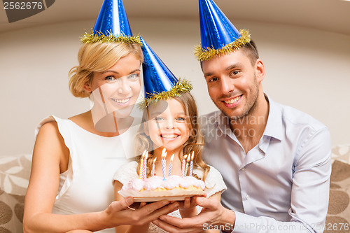 Image of smiling family in blue hats with cake