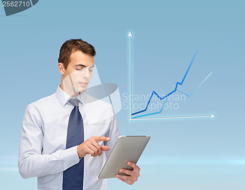 Image of buisnessman with tablet pc and graph