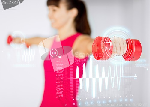 Image of sporty woman hands with light red dumbbells