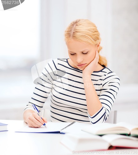 Image of concentrated woman studying in college