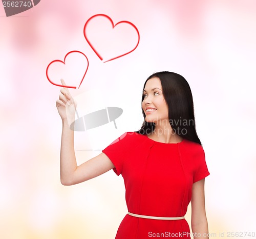 Image of young woman in red dress pointing her finger