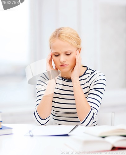 Image of concentrated woman studying in college