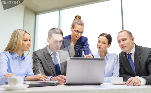 Image of business team with laptop having discussion