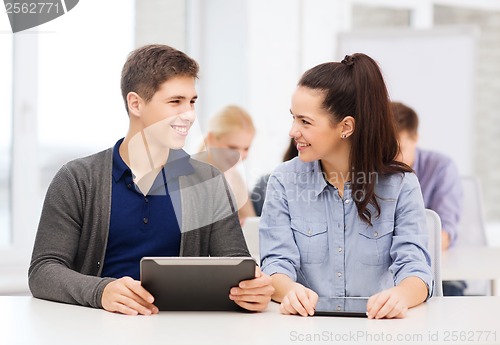 Image of students looking at tablet pc in lecture at school