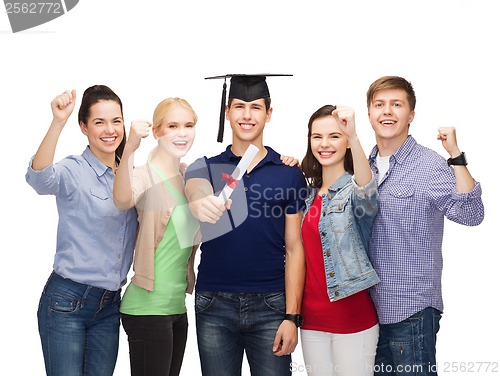 Image of group of standing smiling students with diploma